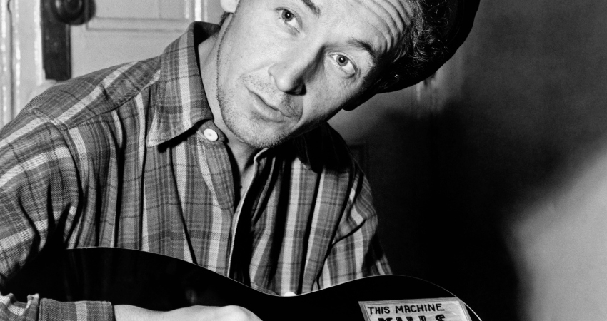 Black and white photo of Woody Guthrie