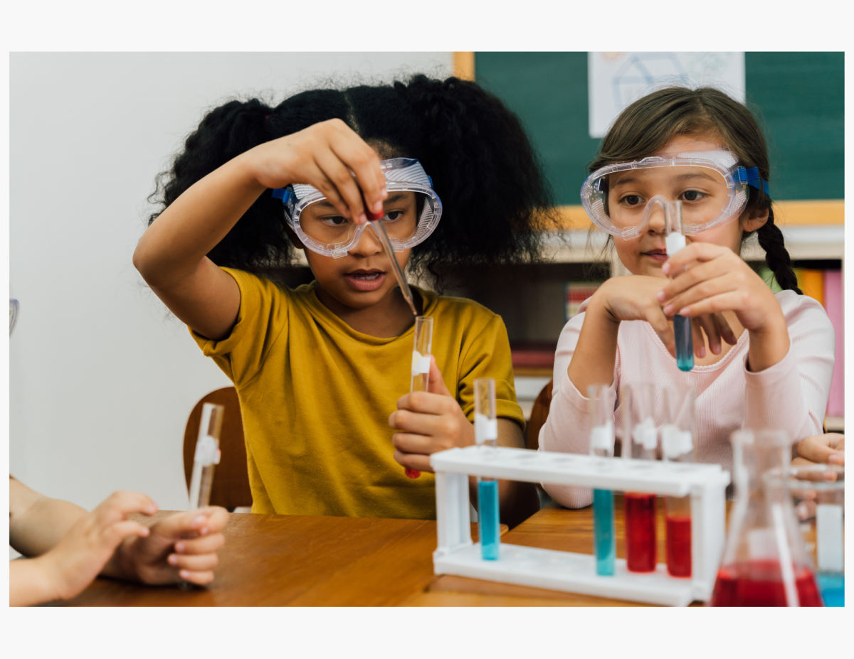 two young girls fill vials with colorful liquid