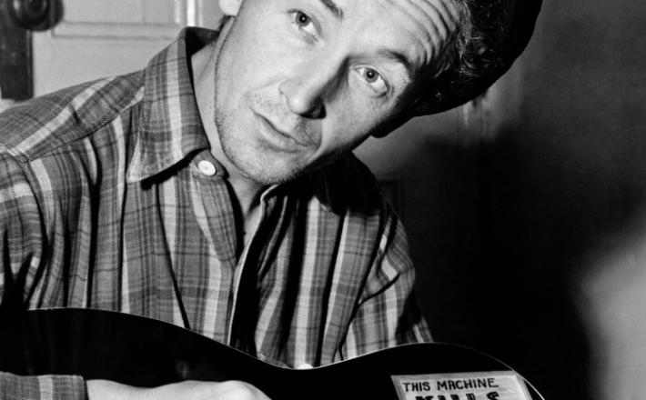 black and white image of Woody Guthrie